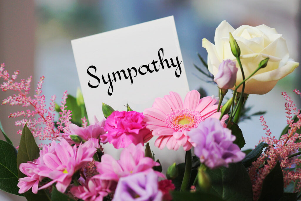 Bouquet of flowers with the word "sympathy" written on the card